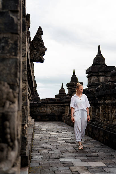 istock Woman exploring ancient temple ruins Borobudur 2238149397