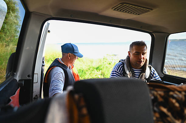 istock Two men preparing for boating at a lake 2238154820