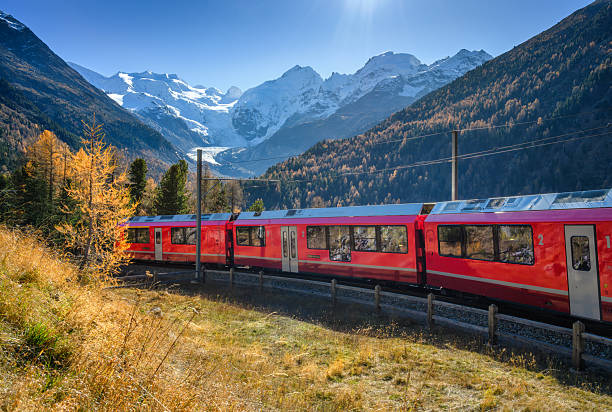 istock Red Bernina Express train passing through colorful autumn forest 2238155409