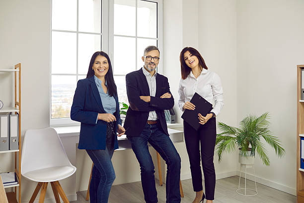 istock Smiling colleagues posing together and smiling at camera 2238156140