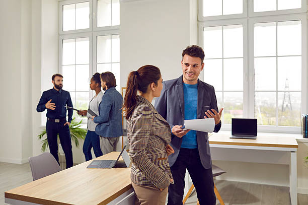 istock Two business colleagues have friendly conversation about work in coworking office. 2238158502