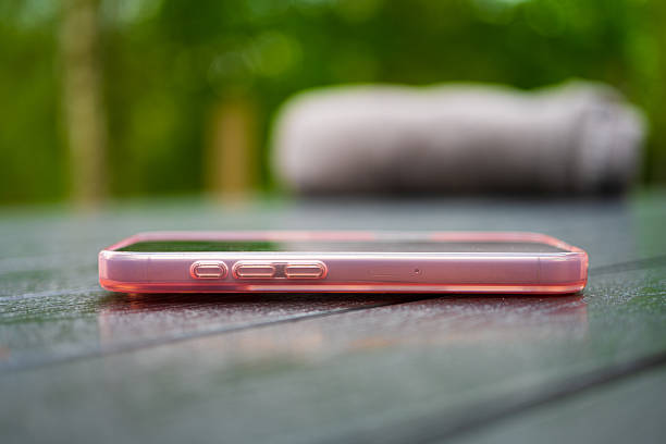 Side view of smartphone on wooden surface..