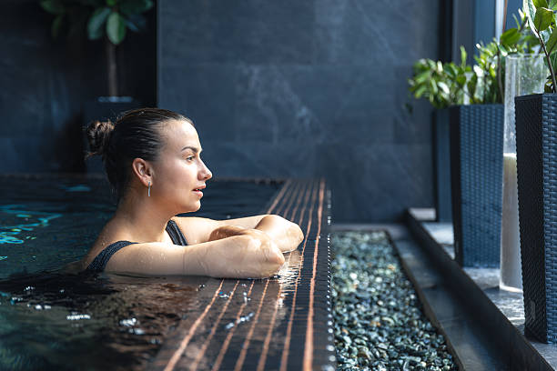 istock Woman relaxing in spa pool by window. Quiet moment. 2238160382