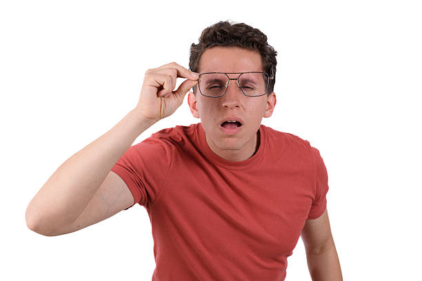 istock Man with red shirt and vision problems trying on glasses against a white background 2238162034