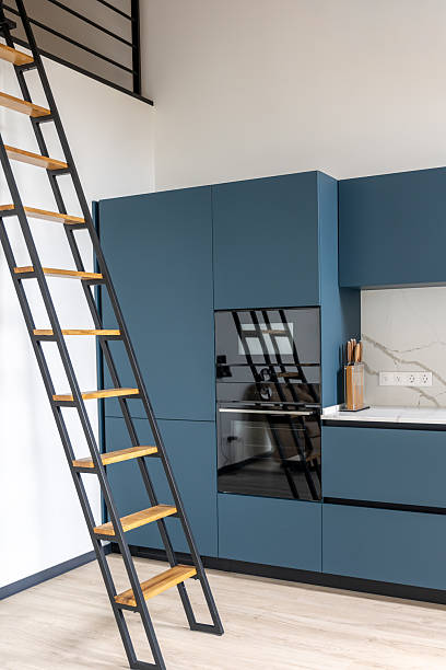 istock Blue kitchen with metal ladder and built in oven. Loft kitchen. 2238162188