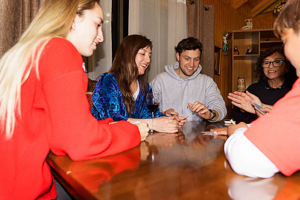 istock Chilean family playing card game at home evening 2238162415