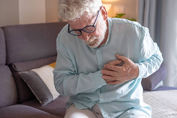 istock Senior man experiencing chest pain at home, holding his chest with a distressed expression. Concept of heart attack, cardiac arrest, chest discomfort, health emergency, or cardiovascular disease in elderly people 2238163155