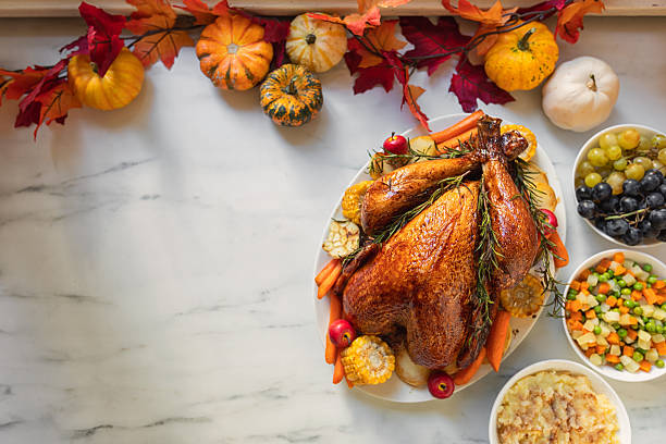 istock Preparing turkey with side dishes for Thanksgiving celebration 2238164885