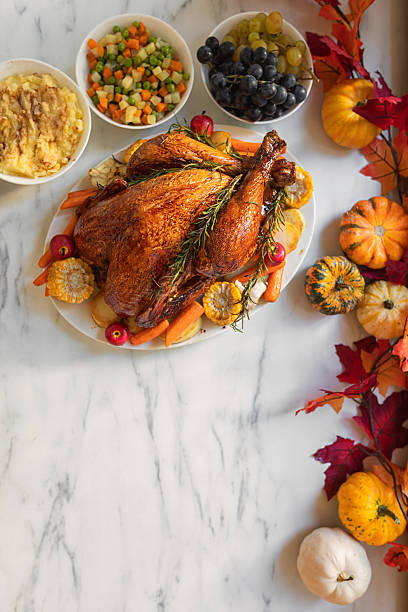 istock Preparing turkey with side dishes for Thanksgiving celebration 2238164897