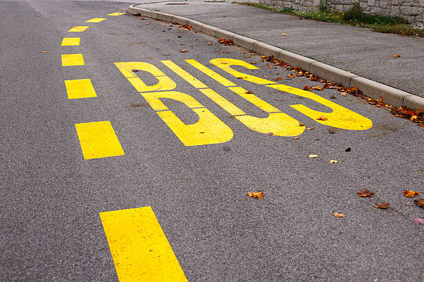 istock Yellow bus stop road marking symbolizing transport 2238164924