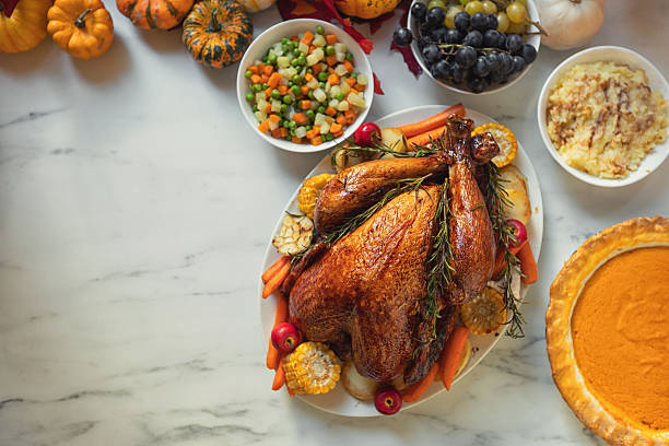 istock Preparing turkey with side dishes for Thanksgiving celebration 2238164945