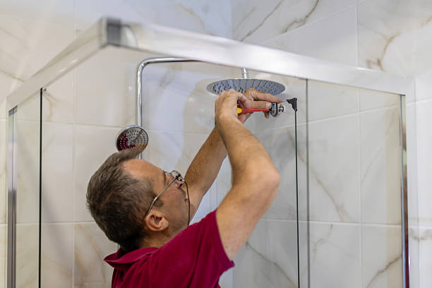 istock A mature plumber fixing shower stall, work in bathroom. 2238165298