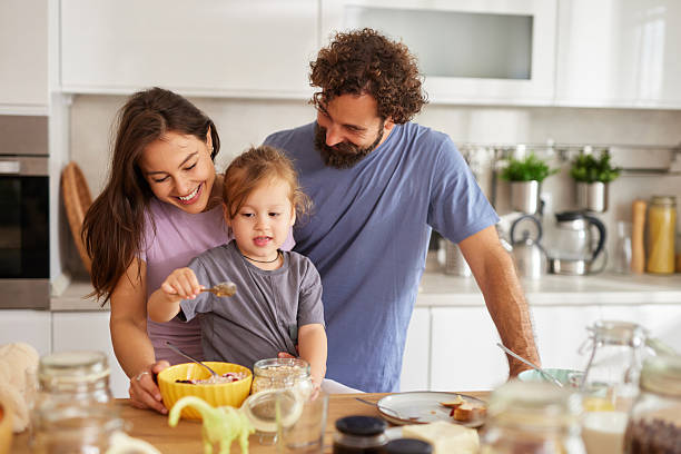 istock Happy family making healthy breakfast in kitchen 2238166981