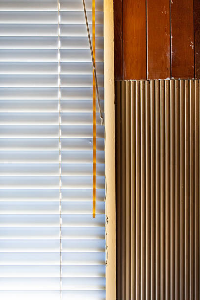 istock Soft Light Through White Window Blinds Next to Rustic Wood Paneling and Vertical Beadboard 2238167842