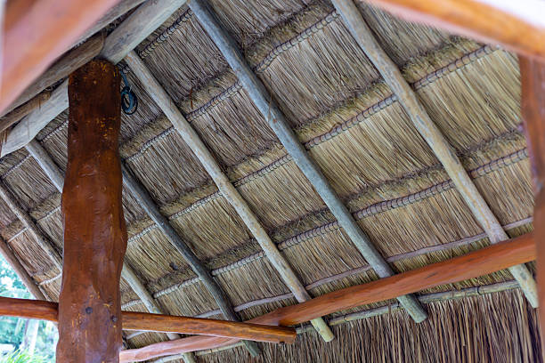 istock Rustic Thatched Roof Interior with Weathered Wooden Beams in a Tropical Hut 2238168607