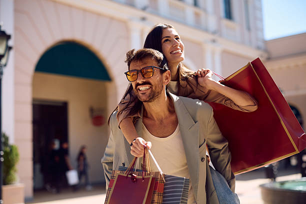istock Carefree couple piggybacking while having fun in shopping. 2238171295