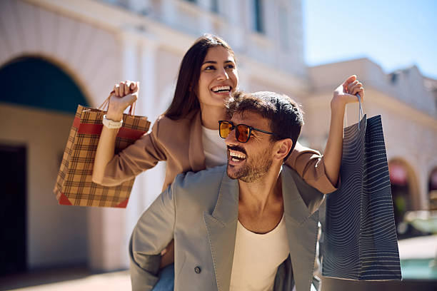 istock Happy couple having fun and piggybacking while shopping together. 2238171298