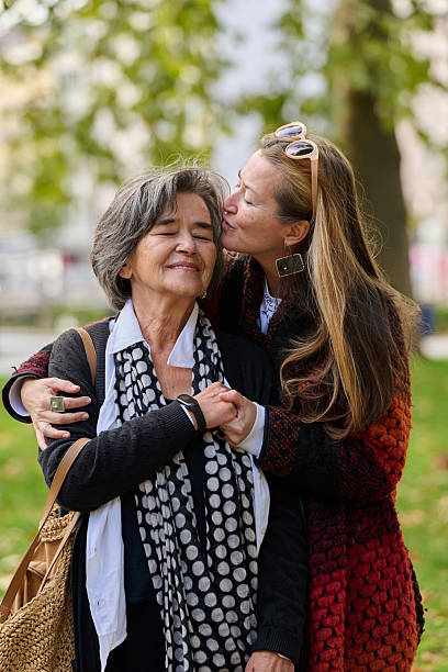 istock A Heartfelt Embrace: A Daughters Support for Her Mother on a Beautiful Autumn Day. 2238177640