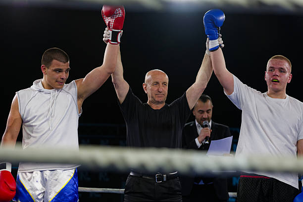 istock Boxing referee declares victorious fighter amidst the aftermath of an intense bout. 2238177946