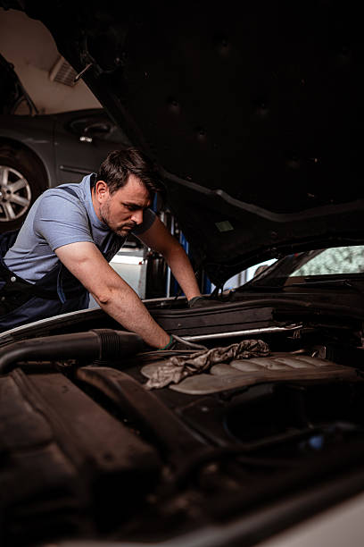 istock Mechanic performing maintenance on car engine in garage during daytime 2238182907