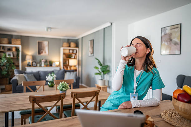 istock Nurse taking a break drinking coffee at home 2238183348