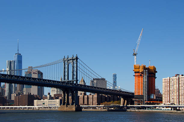 The Brooklyn Bridge and the Modern architecture in Lower Manhattan including one world trade center, downtown districtr, New York City, United States
