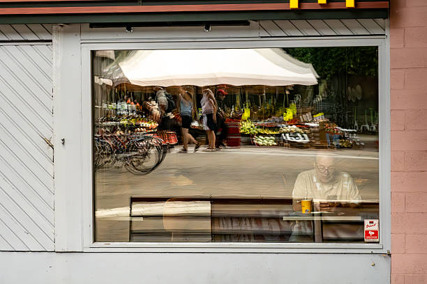 Stockholm, Sweden July 25, 2025 A man sits in the window of a McDonald's restaurant with a coffee.