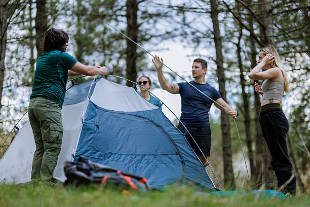istock Friends setting up a camping tent in a forest during a sunny afternoon 2238188091