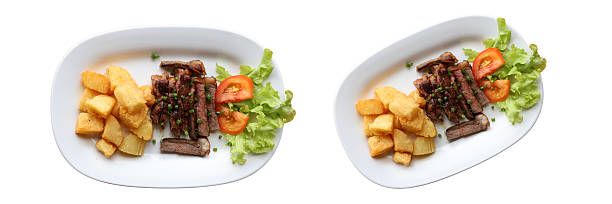 istock Gourmet Dish Display: A visually appetizing arrangement showcasing two exquisite plates, each adorned with a tantalizing selection of culinary delights, offering a perspective view. 2238190564