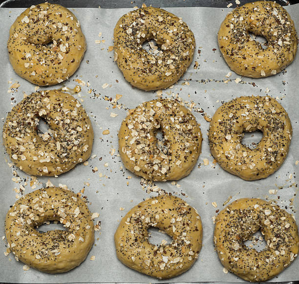 istock Unbaked Everything Bagels on Parchment-Lined Tray — Homemade Baking in Progress 2238191419