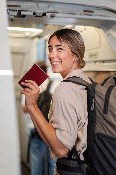 istock Smiling Traveler Boarding Airplane With Passport and Backpack Ready for Adventure 2238198529