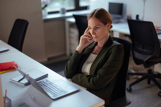 istock Professional Woman Working in Modern Office Environment Using a Laptop 2238199419