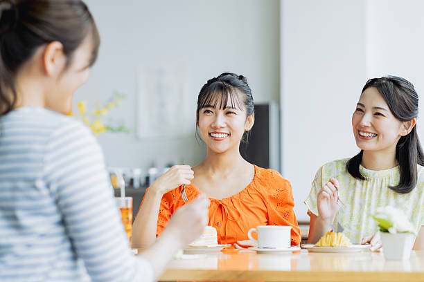 istock Friendly young women having tea in a cafe 2238204434