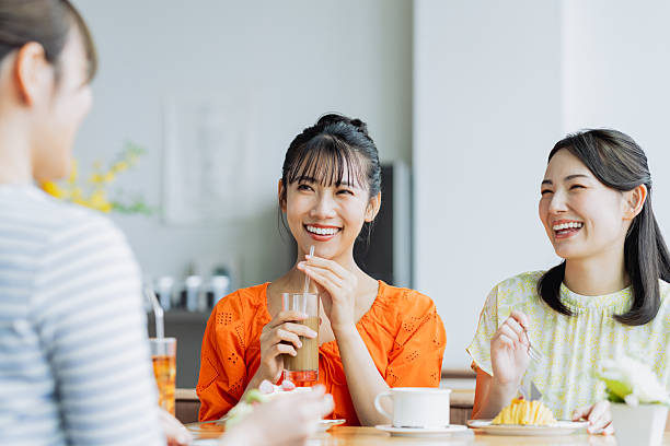 istock Friendly young women having tea in a cafe 2238204437