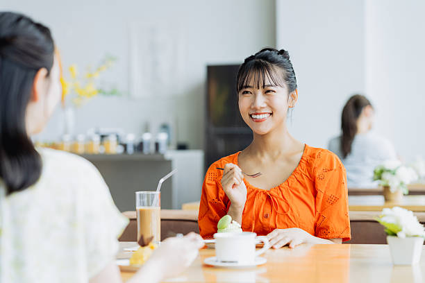 istock Friendly young women having tea in a cafe 2238204438