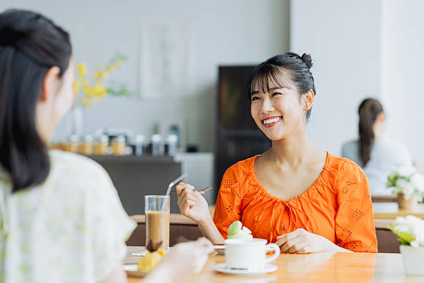 istock Friendly young women having tea in a cafe 2238204439