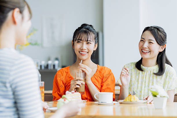 istock Friendly young women having tea in a cafe 2238204441