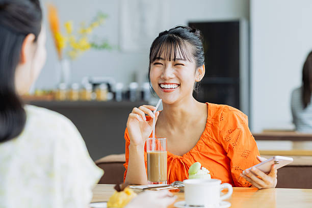 istock Friendly young women having tea in a cafe 2238204450