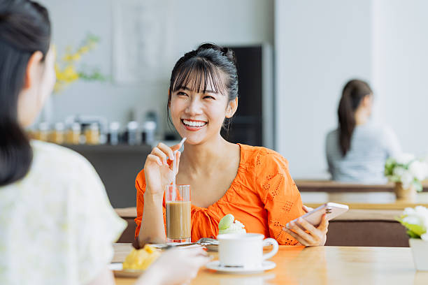 istock Friendly young women having tea in a cafe 2238204453