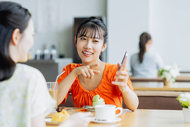istock Friendly young women having tea in a cafe 2238204454