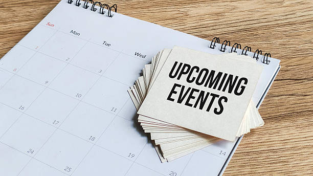 istock Upcoming Events or Important Dates Concept: Stack of Notes with Black Text on a Desk Calendar on a Wood Table. 2238205116