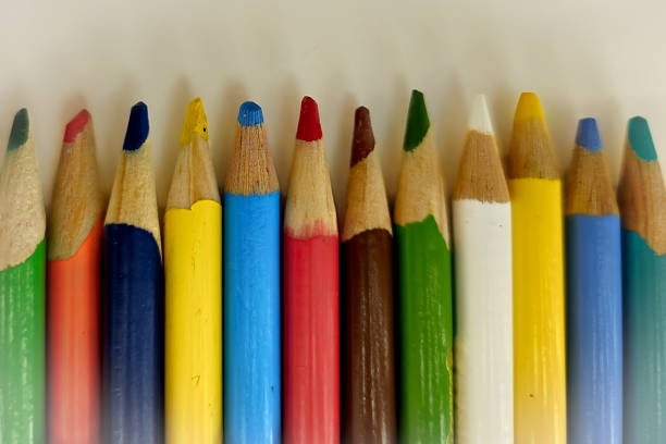 Color image depicting a close up macro abstract view of a collection of colored pencils.