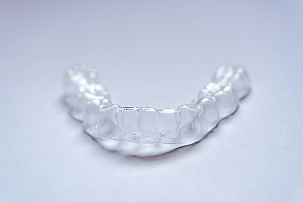 istock clear aligners device in the mouth on a white background. (invisalign) 2238211740