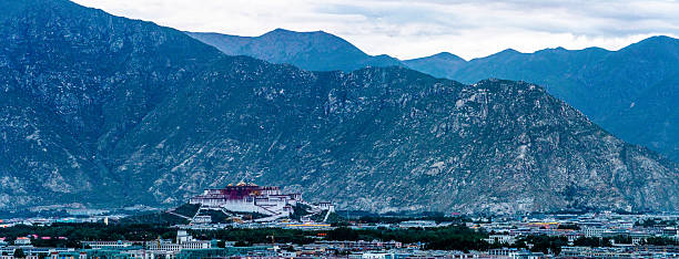 Panoramic view of the Potala Palace, the iconic former residence of the Dalai Lama, set against the mountains of Lhasa, Tibet.