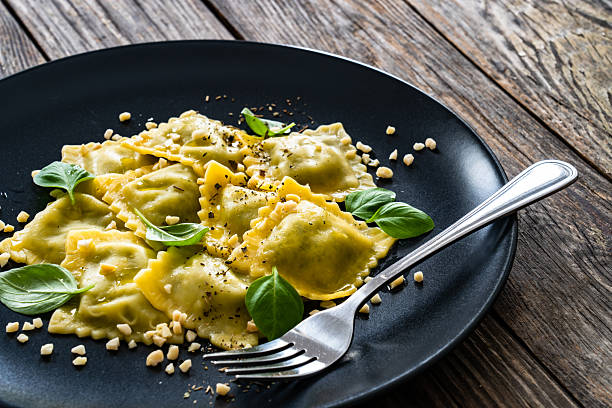 istock Ravioli with basil leaves and pine nuts on wooden table 2238212150