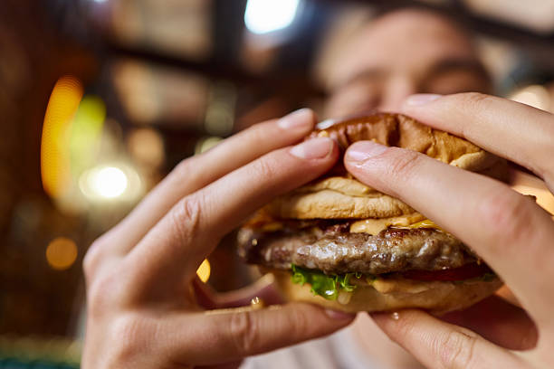 istock Close up of eating hamburger. 2238221250