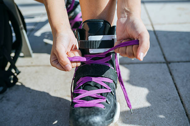 istock Skater tying laces on inline skates 2238221927