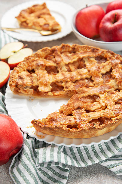 istock Homemade apple pie with a slice and fresh apples 2238222881