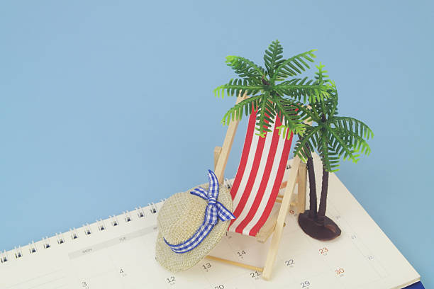 istock Red beach chair with hat and palm tree on calendar on blue background. 2238225057