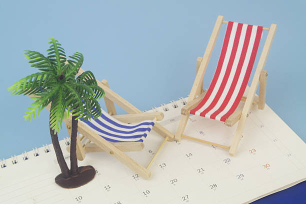istock Red and blue beach chairs with palm tree on calendar on blue background. 2238225076